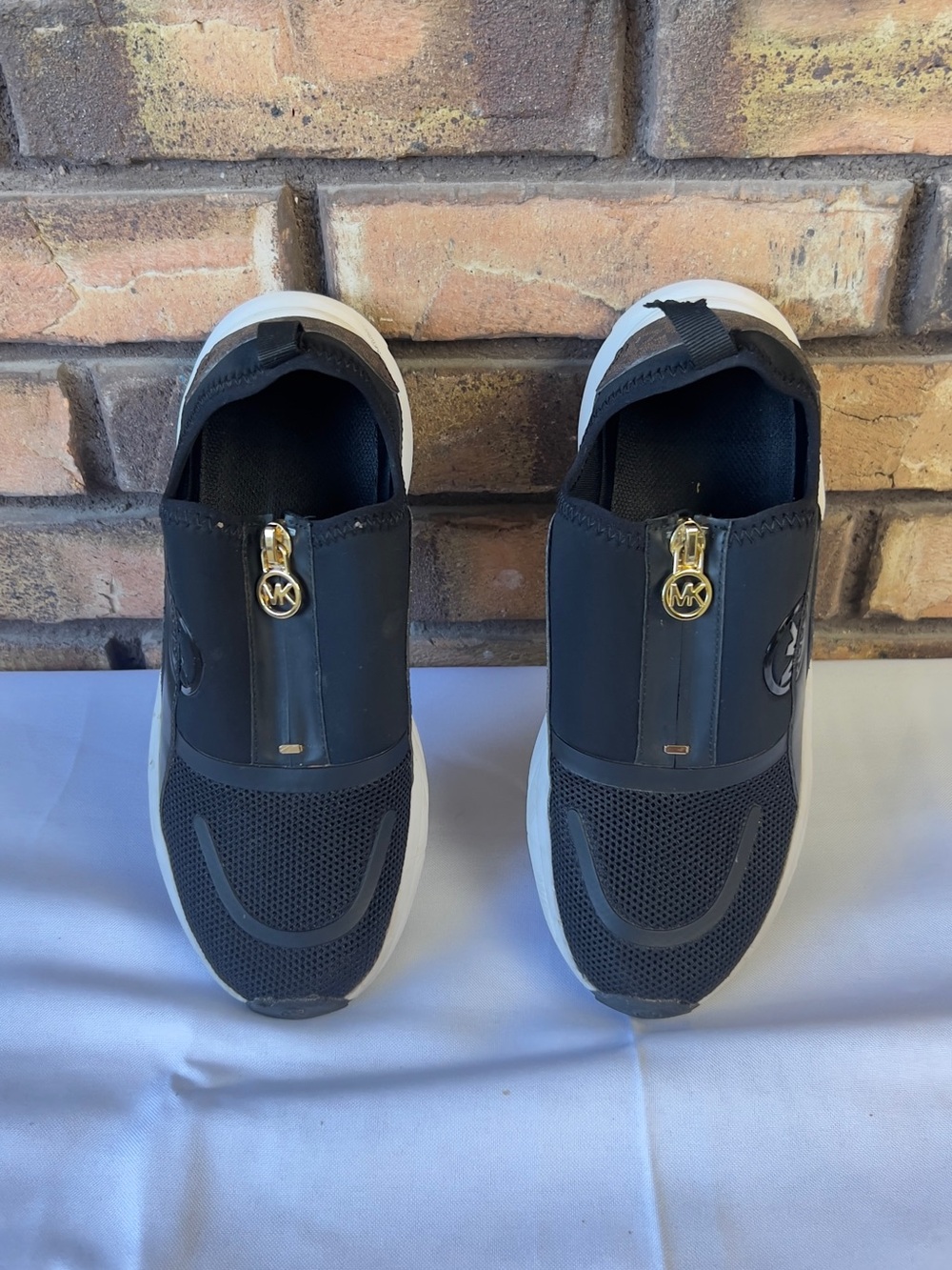 Michael Kors Black Slip-On Sneakers with Gold MK Charm